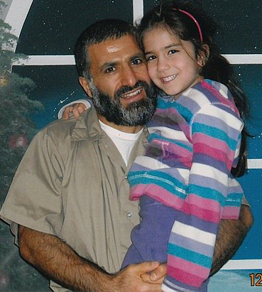 Yassin Aref holds his daughter during a rare prison visit